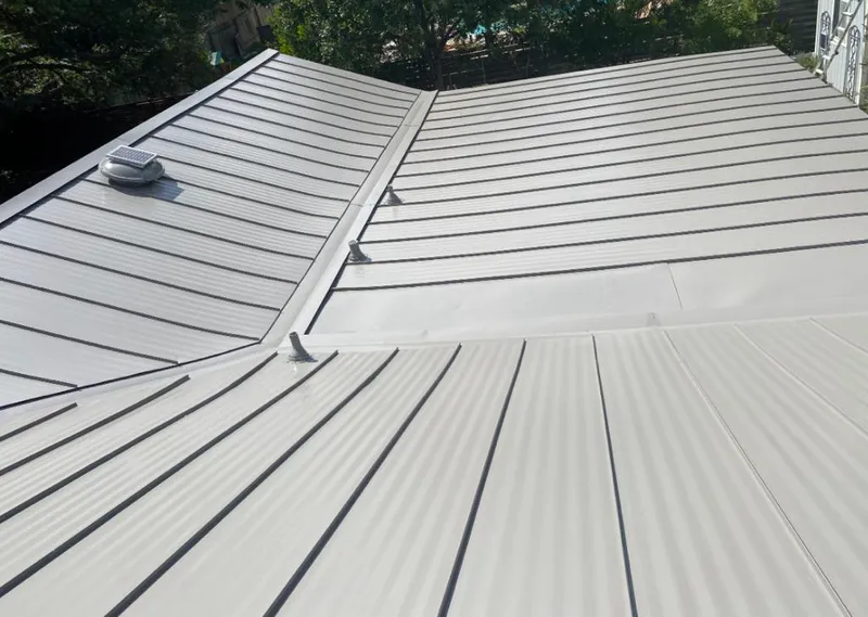 Solar attic fan installed on a metal roof for Roof Ventilation in Spring Creek